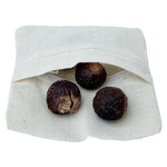 Reusable cotton wash bag containing natural soap nut shells